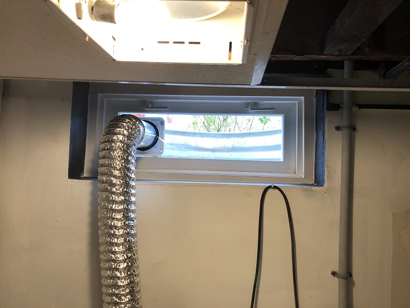 Custom basement window with a dryer vent 